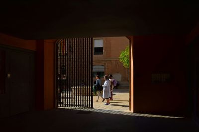 People walking in corridor of building