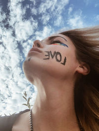 Close-up portrait of woman against sky