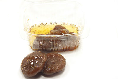 High angle view of breakfast in glass jar on white background