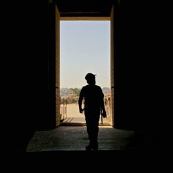 Rear view of man at doorway in building