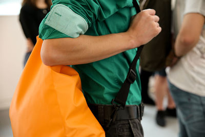 Midsection of student carrying backpack