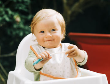 Portrait of cute girl holding camera