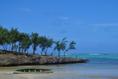 Scenic view of sea against blue sky