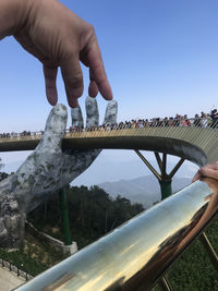 Low angle view of person against blue sky