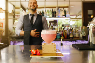 Bartender making drink at bar