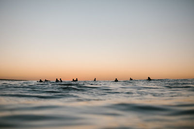 Group of surfers under the sunset in the canary islands