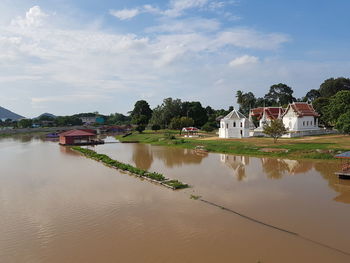 Scenic view of lake by building against sky