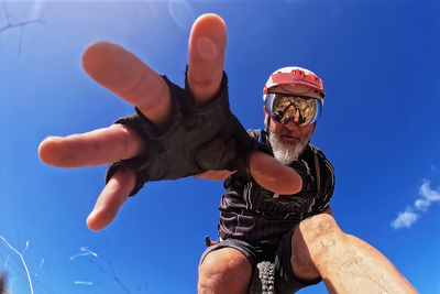 Low angle view of woman with arms raised