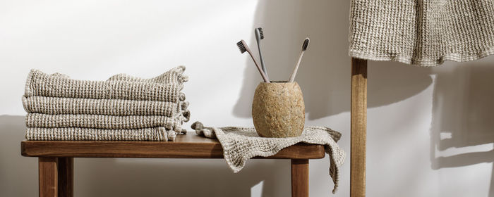 Close-up of chair on table against wall at home