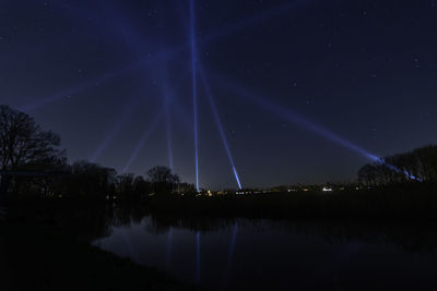 Scenic view of lake against sky at night