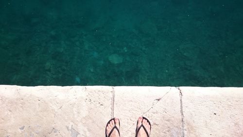 Low section of person in swimming pool