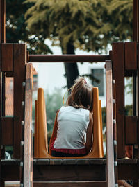 Rear view of woman sitting on seat