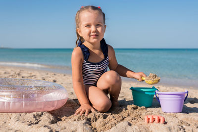 Full length of girl on beach against sky