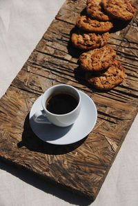 High angle view of coffee and cookies on table