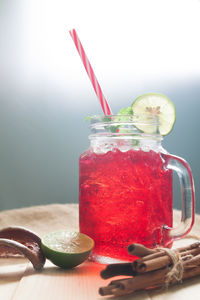 Close-up of drink on table against wall