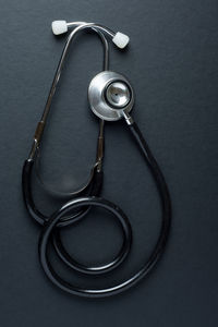 Directly above shot of stethoscope on black background