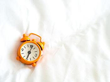 Close-up of clock on bed