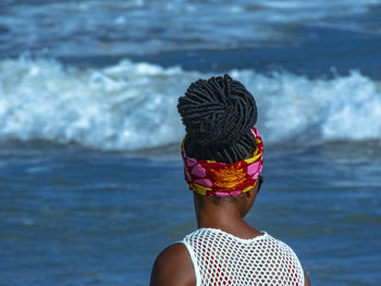 Rear view of woman wearing hat at beach