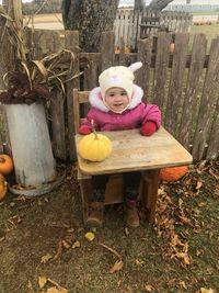 Portrait of cute girl sitting outdoors