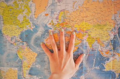 Woman's hand on the world map