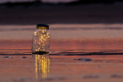 Close-up of glass bottle on table
