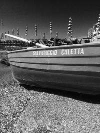 Boats moored on land against sky in city