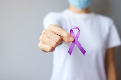 Rear view of woman holding hands over white background