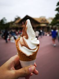 Close-up of hand holding ice cream cone