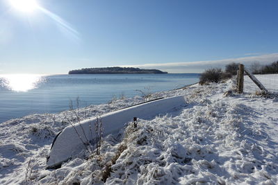 Scenic view of snow covered landscape against blue sky