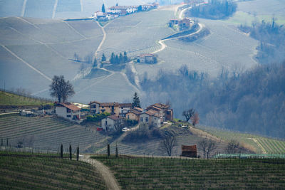 Panoramic view of agricultural field against buildings