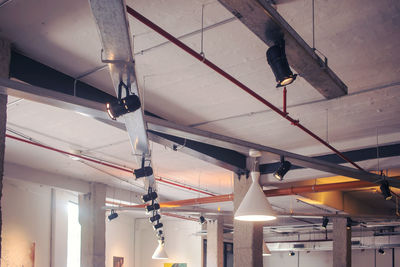 Low angle view of illuminated pendant lights hanging from ceiling