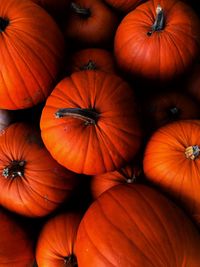 Full frame close-up of fresh organic orange pumpkins on a market stall