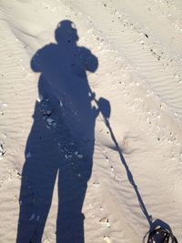 Shadow of man playing on sand