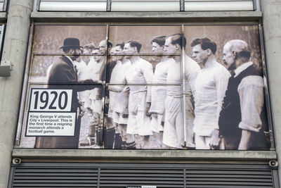 Group of people standing in front of a sign