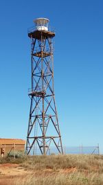 Low angle view of water tower against clear blue sky