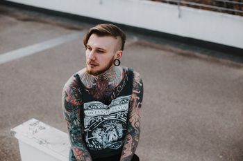 MAN LOOKING AWAY WHILE STANDING ON ROAD