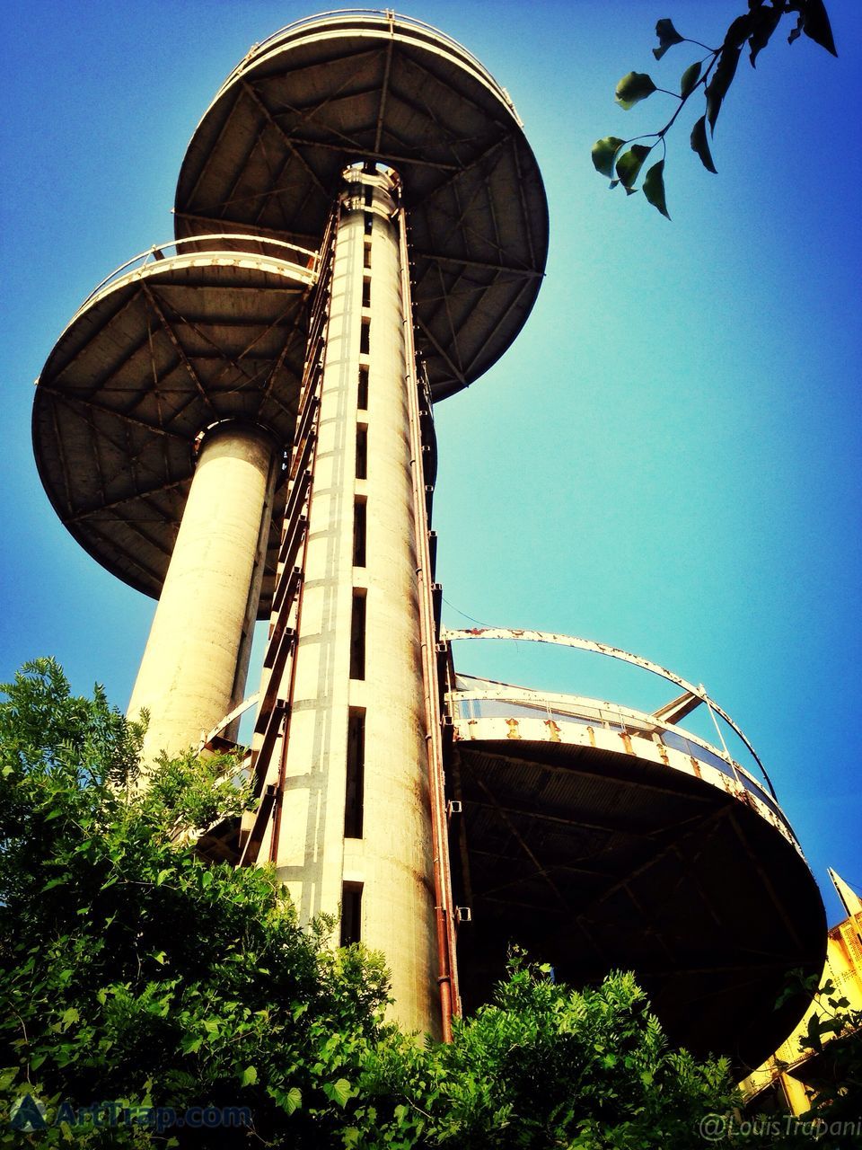 clear sky, architecture, built structure, low angle view, building exterior, blue, tree, ferris wheel, arts culture and entertainment, amusement park, amusement park ride, travel destinations, copy space, tower, sky, famous place, travel, outdoors, day, tourism