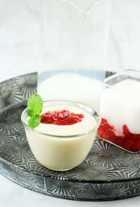 Strawberry pannacota on mini bowl, italian traditional dessert with jelly and strawberry compote