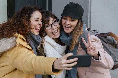 Smiling women using smart phone 