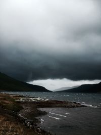 Scenic view of mountains against cloudy sky