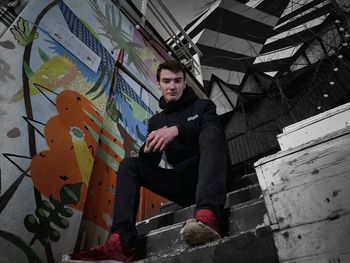 Portrait of young man sitting outdoors