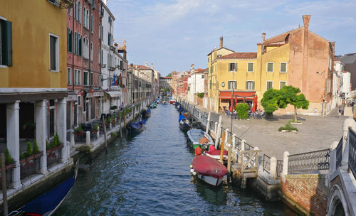 Canal passing through buildings in city