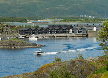 Scenic view of sea and buildings against mountain