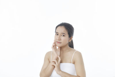 Portrait of woman against white background