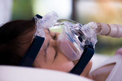 Close-up of woman with oxygen mask