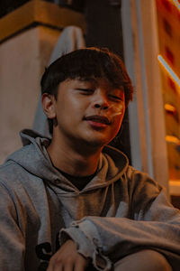 Portrait of young man sitting at home