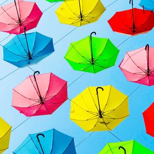 Low angle view of multi colored umbrellas hanging on umbrella