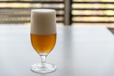 Clos-up of beer in glass on white table