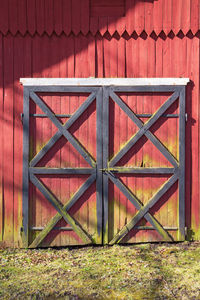 Closed metal gate of red building