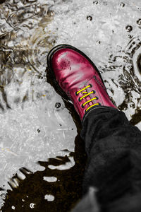 Low section of person standing on snow